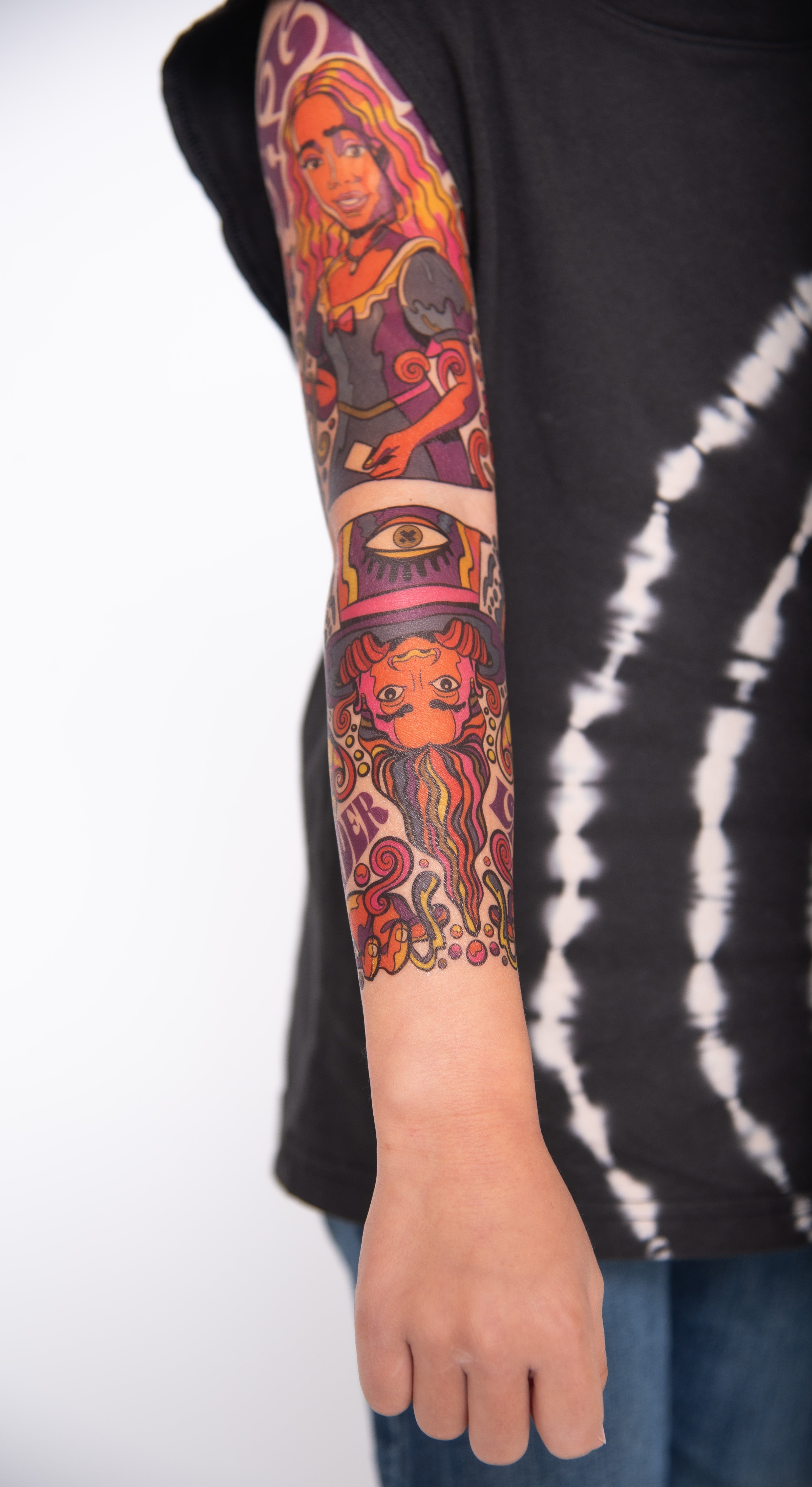 temporary tattoo sleeve for kids with colorful illustrated characters covering the full arm in a realistic kids tattoo sleeve design
