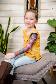 Girl shows off her fake tattoo sleeve depicting a Desert.