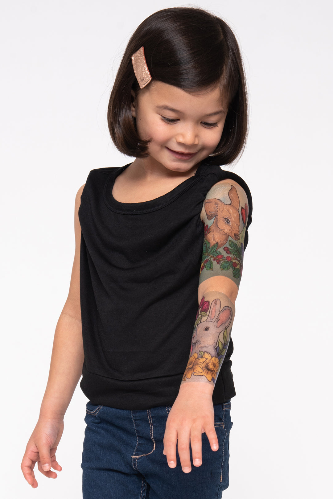 Girl shows her easter sleeve with a deer and a bunny along with lovely flowers and eggs.