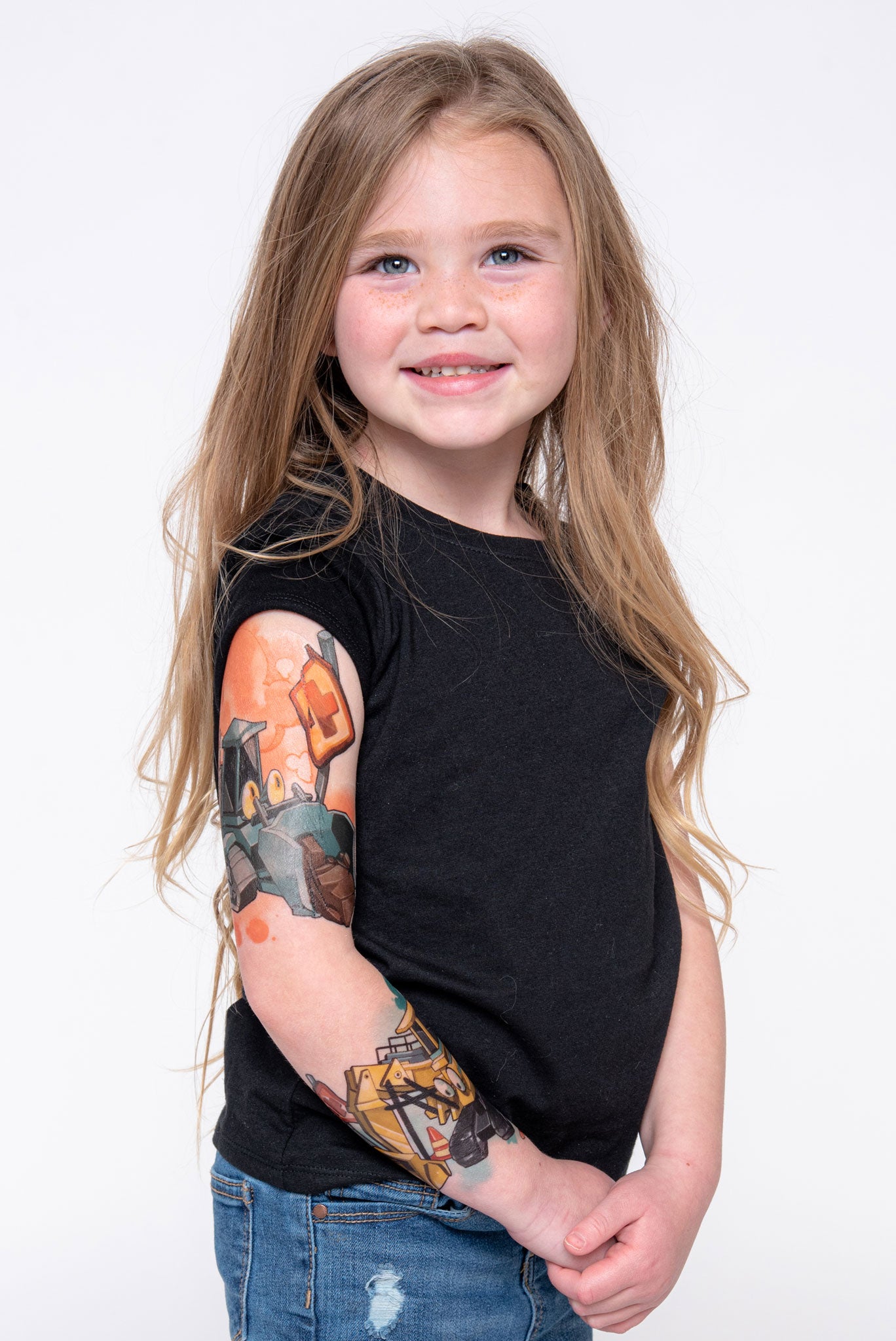 Young girl shows off her construction temporary tattoo sleeve.